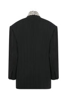 Gray oversized jacket by TAGG with hand-embellished collar detail, shown from the front on a plain background.