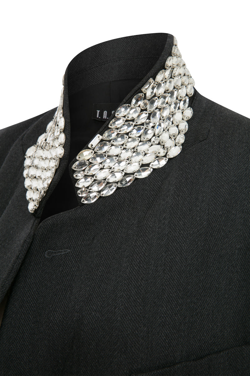 Gray oversized jacket by TAGG featuring hand-embellished collar details and a relaxed fit, displayed on a hanger.