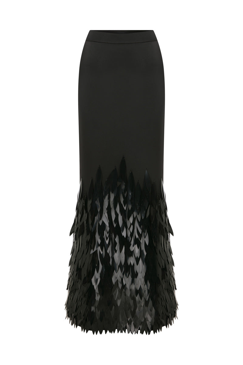 Black embellished mermaid maxi skirt by TAGG, featuring fitted waist, flowing fabric, and decorative embellishments for elegant style.