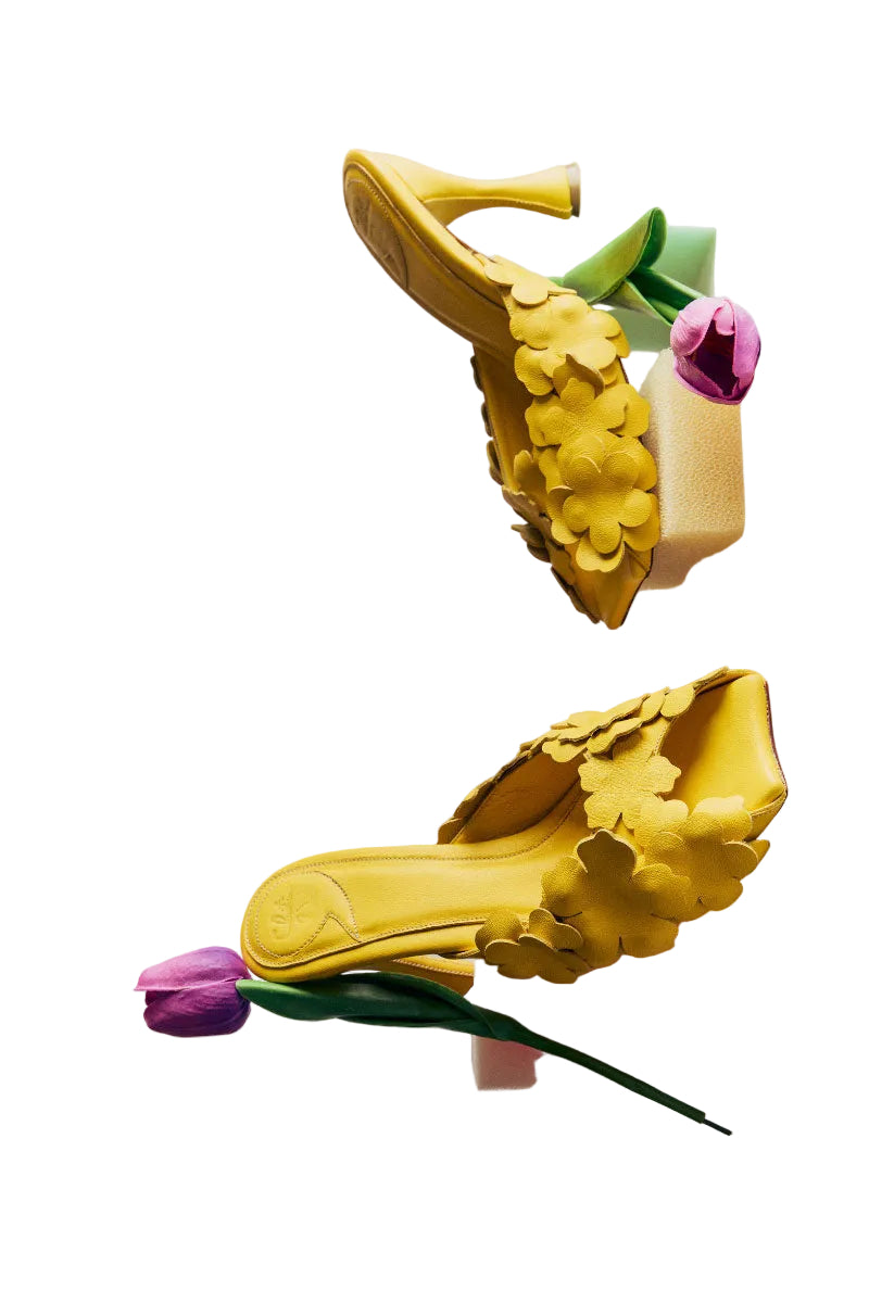 Yellow Christin Wu YUKI heels sandals with sleek straps, shown in a stylish lifestyle setting.