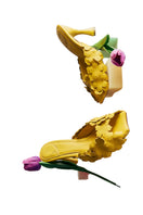 Yellow Christin Wu YUKI heels sandals shown in a lifestyle setting with stylish design and comfortable straps.
