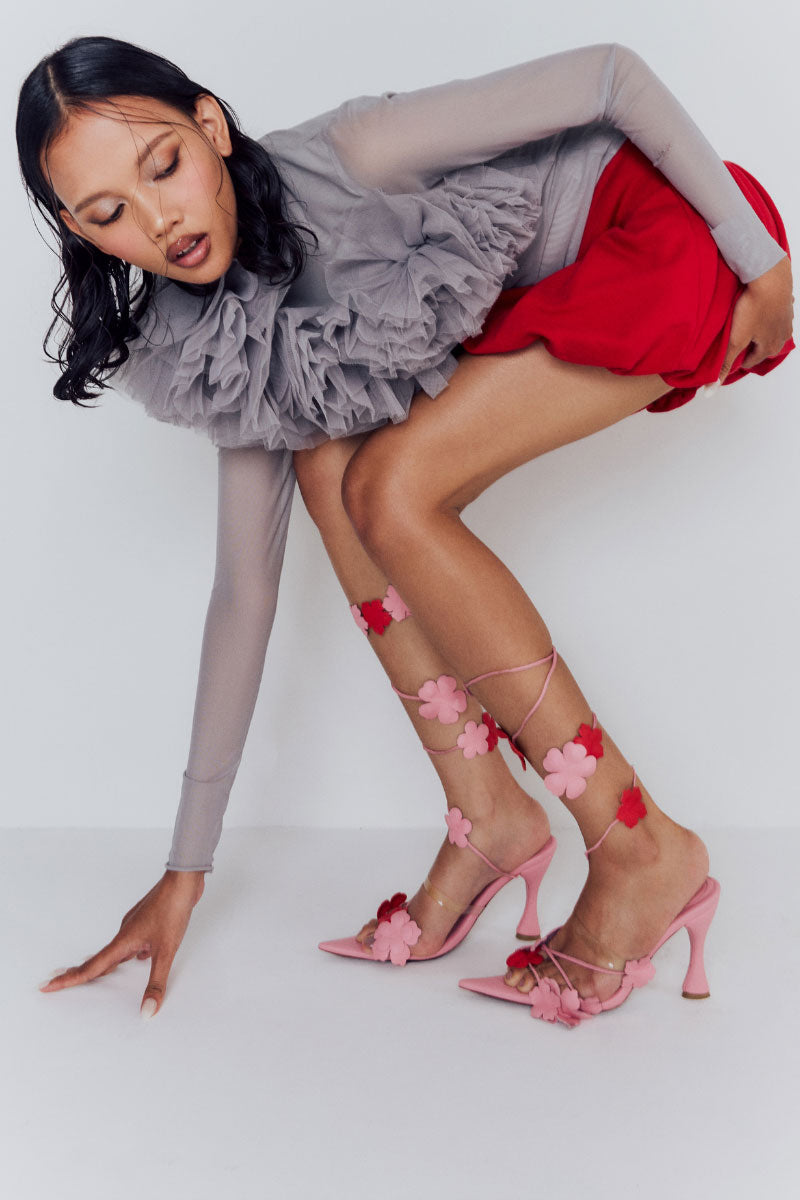 Christin Wu YURELLE heels sandals featuring a sleek design, shown in a stylish lifestyle setting with open-toe and ankle strap details.