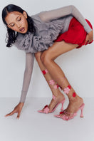 Christin Wu Yurelle heels sandals featuring sleek straps and a stylish design, worn in a lifestyle setting.