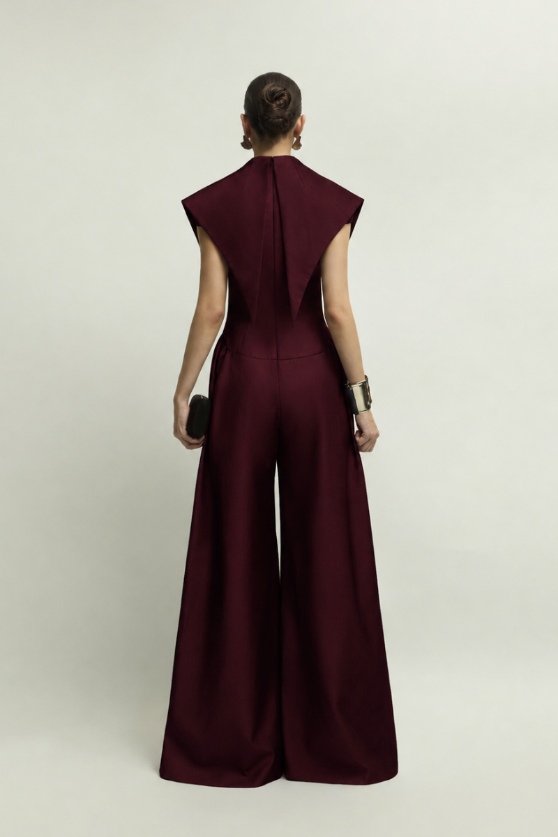 Jenny K Tran Zelie burgundy jumpsuit showing a stylish, fitted design with long sleeves and a tapered leg silhouette.