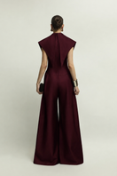 Jenny K Tran Zelie burgundy jumpsuit showing a stylish, fitted design with long sleeves and a tapered leg silhouette.