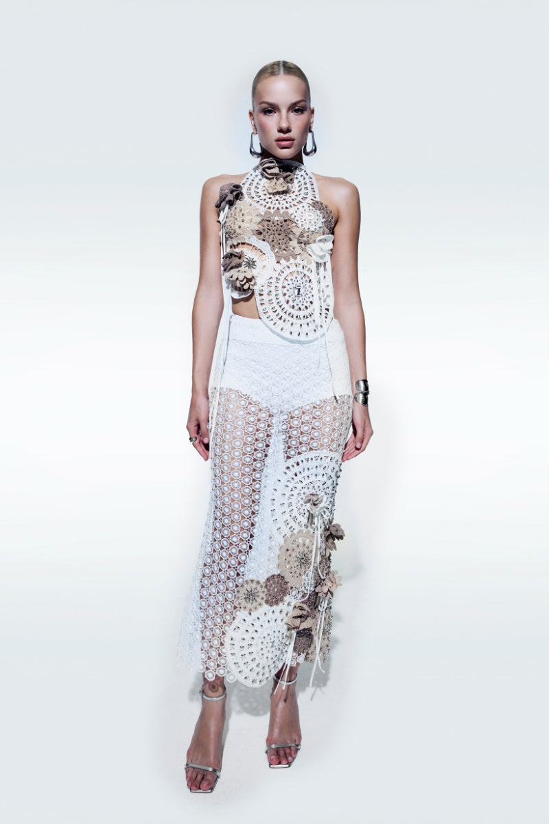 Zeynep Tosun asymmetrical broderie top in off-white with intricate embroidery and elegant design, displayed on a neutral background.