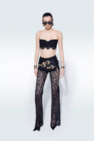 Black mini lace bra top by Zeynep Tosun, featuring delicate lace details and a fitted style, perfect for stylish layered looks.