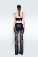 Black mini lace bra top by Zeynep Tosun, featuring delicate lace details and a fitted design, shown on a model.