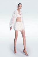 Zeynep Tosun broderie off-white mini skirt with intricate embroidery, styled with a fitted waist and lightweight fabric.