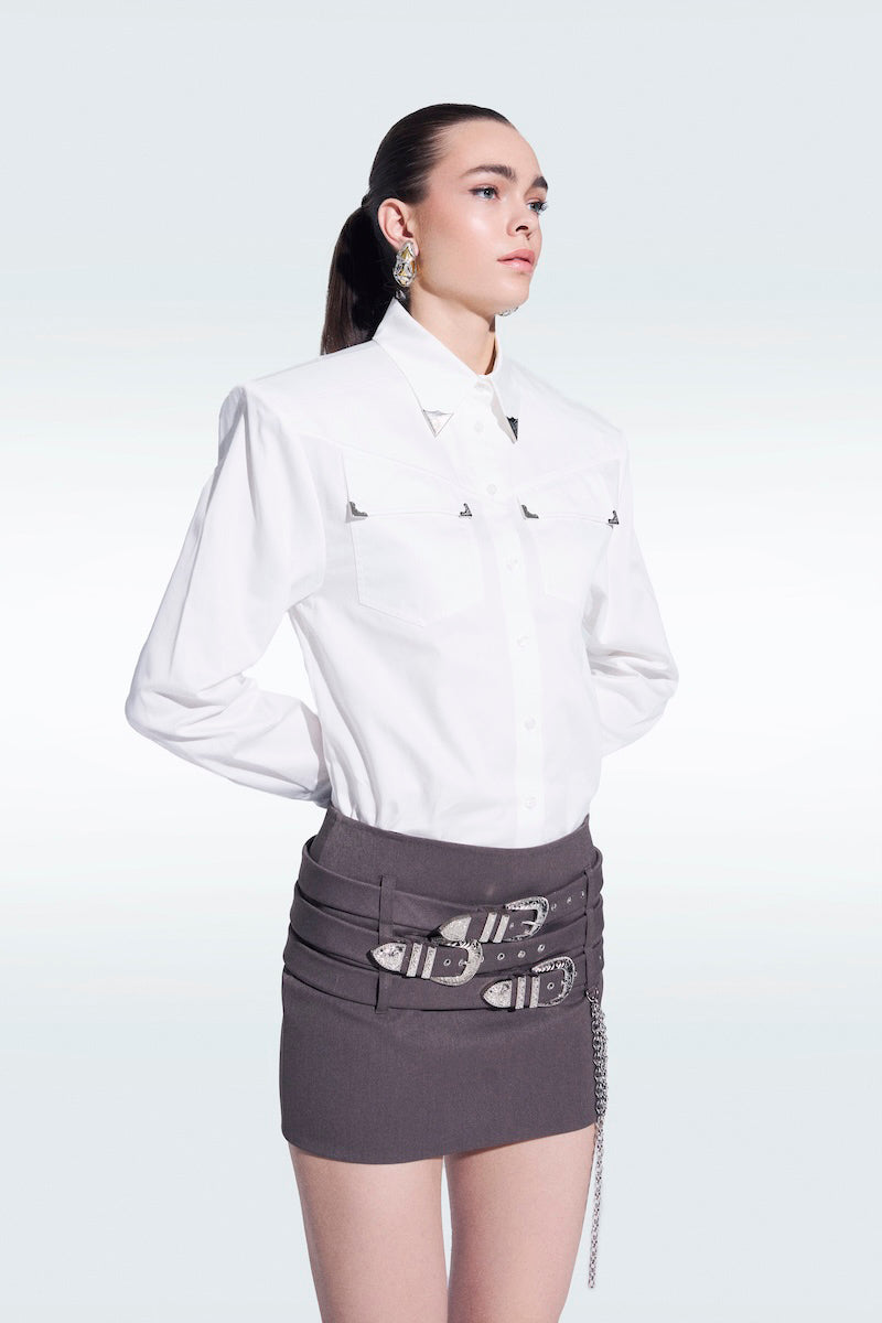 Gray Zeynep Tosun mini skirt with attached belts, shown on a model, highlighting its stylish and contemporary design.