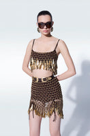 Hand-knit metallic brown mini skirt by Zeynep Tosun, showing close-up of textured knit fabric and metallic sheen.