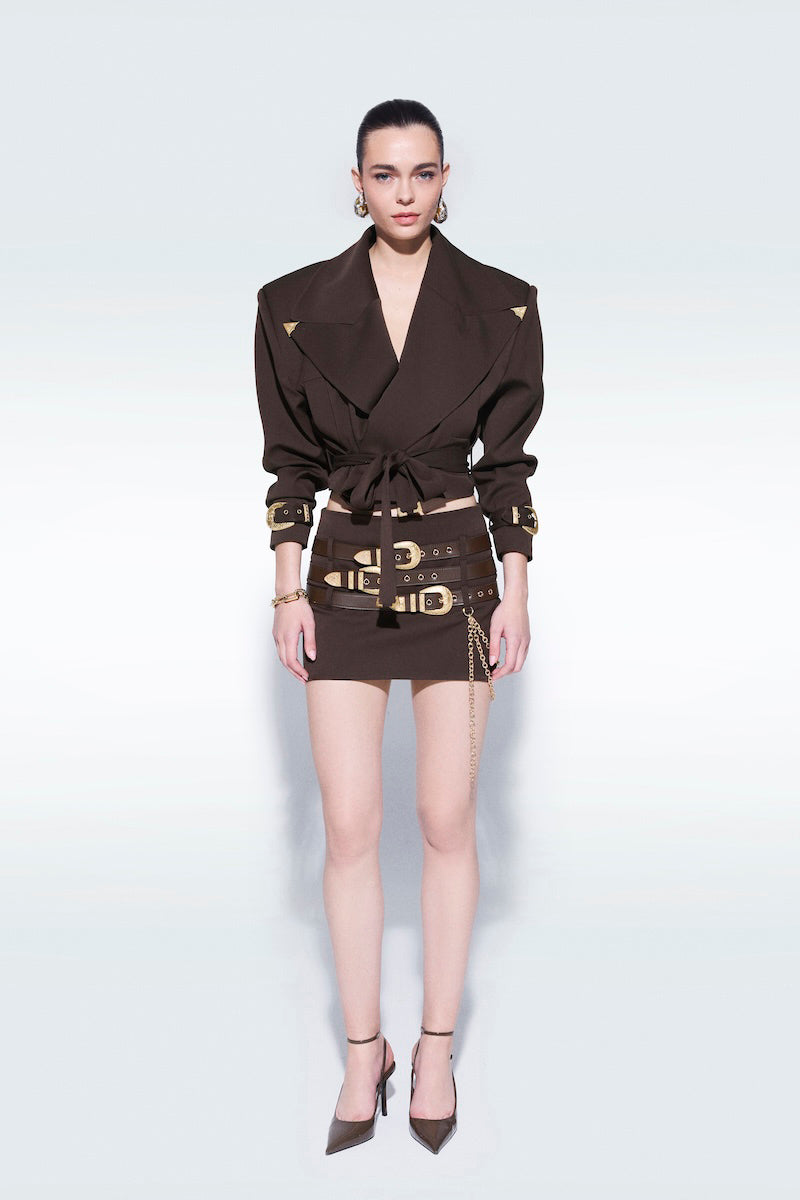 Brown mini skirt with belts by Zeynep Tosun, featuring a stylish fit and fashionable design, shown in the image.