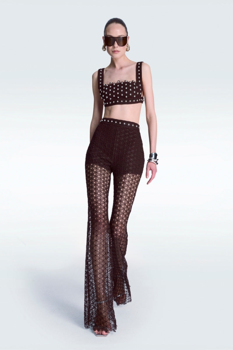 Brown broderie pants by Zeynep Tosun with intricate embroidery and a tailored fit, shown on a model.
