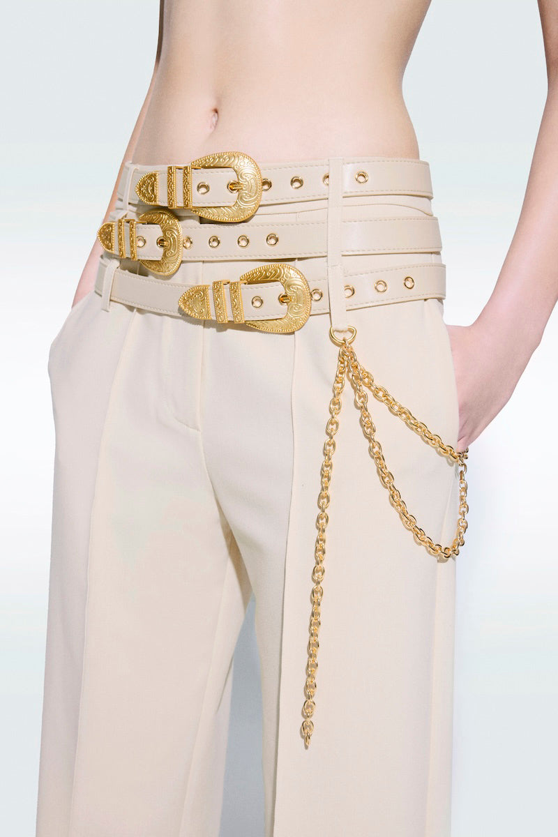 Beige Zeynep Tosun pants with matching belt, stylish tailored design, shown on a model.