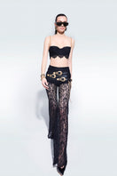 Black lace pants with belts by Zeynep Tosun, featuring intricate lace details and stylish belt accents.