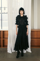 Black draped A-line maxi dress with floral details from Lalo, featuring elegant flowy fabric and stylish design.