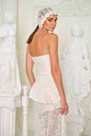 Nana Gotti Zephyra midi dress in flowing fabric with a fitted waist and elegant design, displayed on a model.
