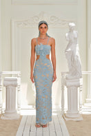 Nana Gotti Zeyna Maxi Dress in flowing fabric with a fitted waist and elegant neckline, perfect for summer occasions.