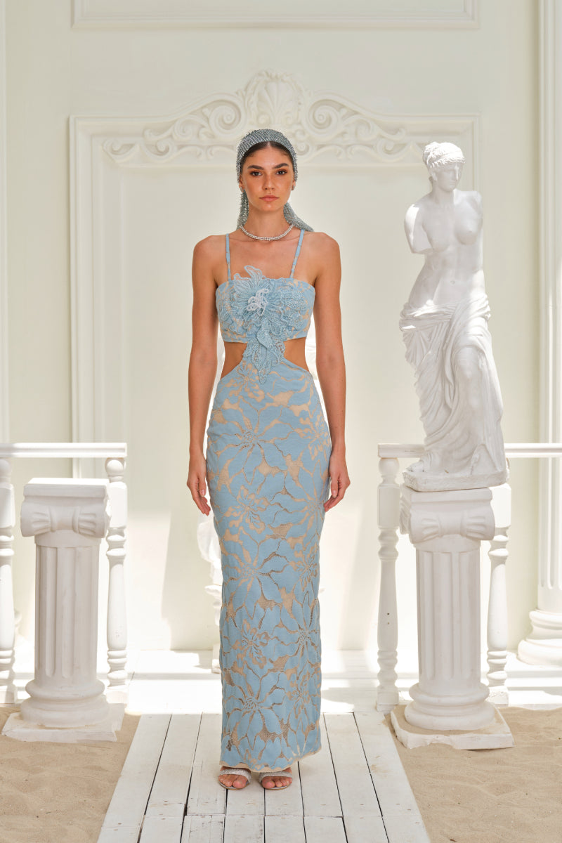 Nana Gotti Zeyna Maxi Dress in flowing fabric with a fitted waist and elegant neckline, perfect for summer occasions.