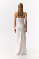 Serenity ZOE white silk satin maxi gown displayed on a hanger, showcasing its elegant flow and smooth fabric.