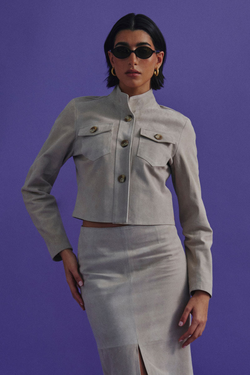 ZUT ZUKE cropped jacket in sandy beige fabric, stylish design with a collar and button front, displayed on a plain background.
