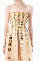 Elegant champagne metallic gown by Happy Clothing featuring heart embellishments and a flowing, glamorous design.
