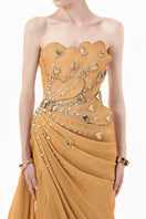 Elegant chartreuse gold gown with heart embellishments and draped design by Happy Clothing, shown on a mannequin.