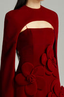 Red velvet Preston Cape gown by Happy Clothing featuring a flowing petal design and elegant silhouette.