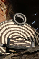 Black Zenú large leather and caña flecha bag by Adriana Castro, featuring a top handle and woven design.