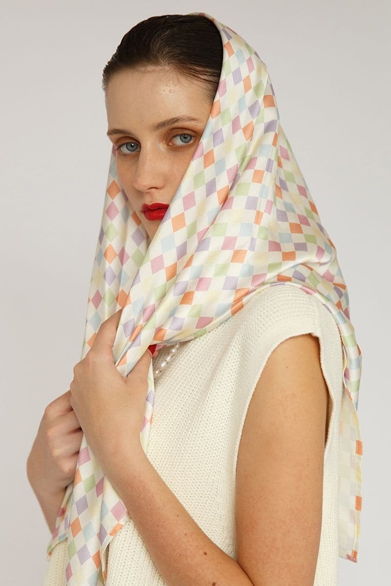 Aethera checked Charlotte silk square scarf and Isla silk front tie pareo set in multicolor, styled as hair accessories.