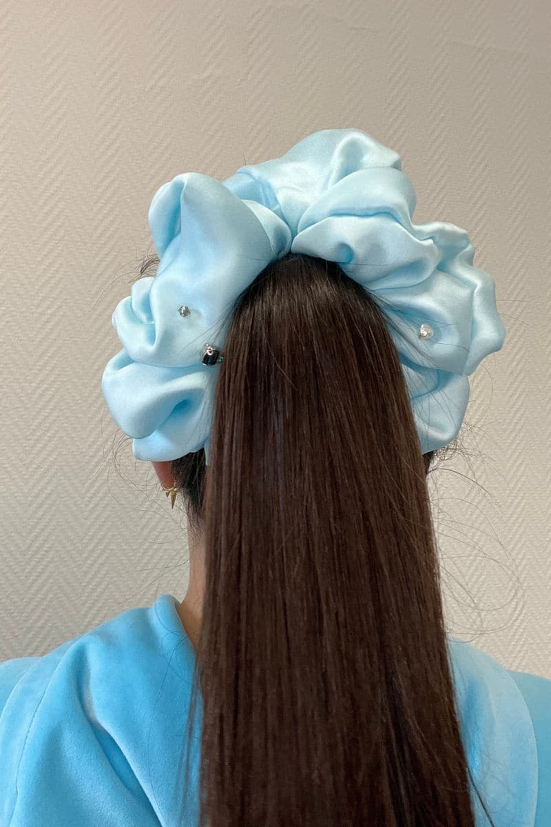 Aqua blue Aethera Cult Mia X Aethera Harlow embellished scrunchie made of soft fabric with decorative accents for hair accessories.