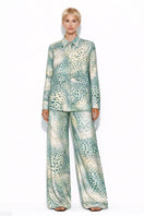 Creamy Moussard silk pants by Amel Batita, featuring a smooth, elegant fabric and tailored fit, displayed on a model.