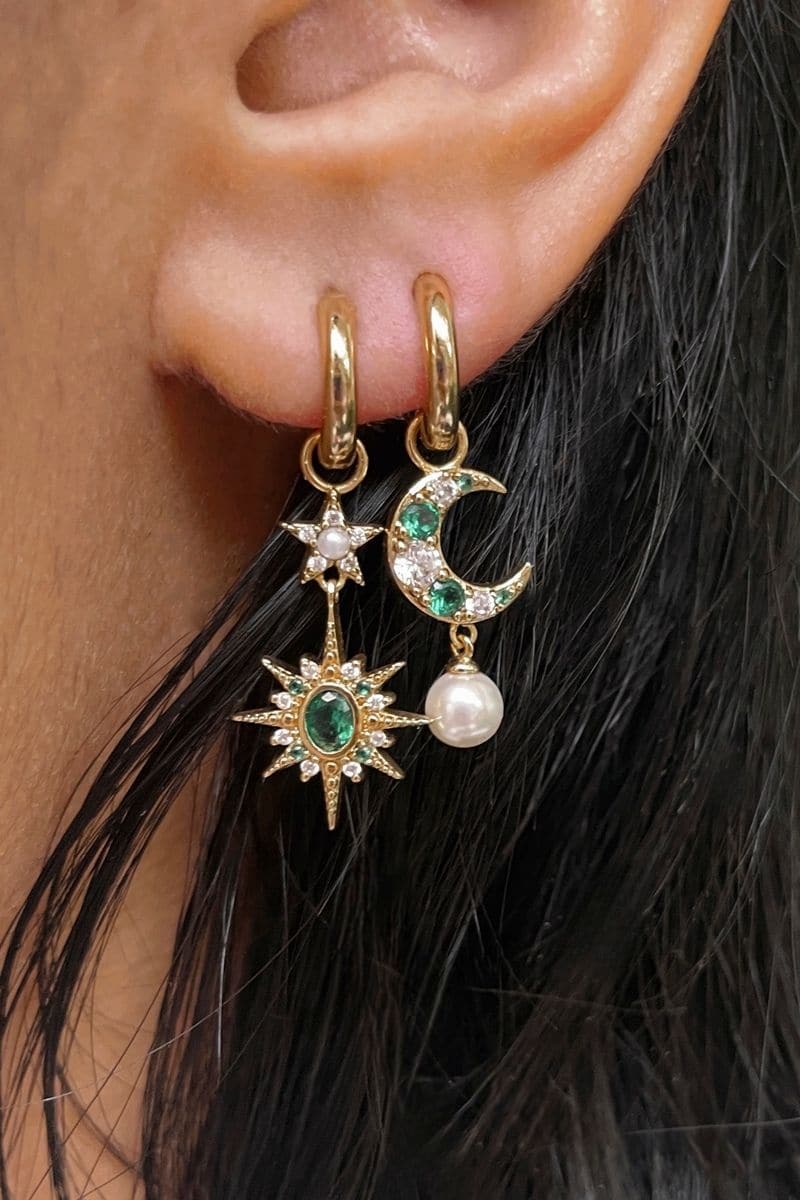 Gold and green Luna earrings by Amelia Scott featuring emerald green accents and intricate gold design.