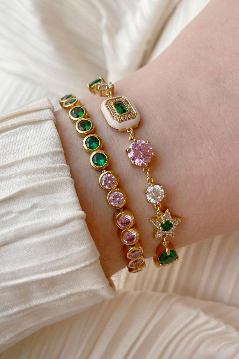 Gold Celeste bracelet by Amelia Scott featuring emerald green accents and delicate chain design.