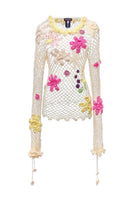 Multicolor handmade crochet top by Andreeva featuring intricate crochet patterns, shown in a close-up of the top's detailed design.