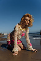 Multicolor handmade crochet top by Andreeva, featuring intricate patterns and a fitted design, displayed on a neutral background.