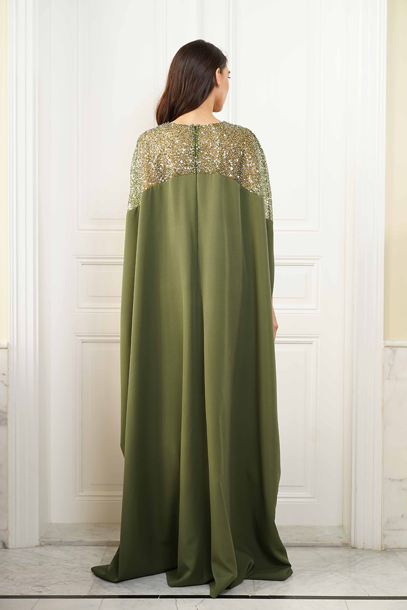 Back view of Joanna Andraos embroidered olive green gown with intricate embroidery and flowing fabric.