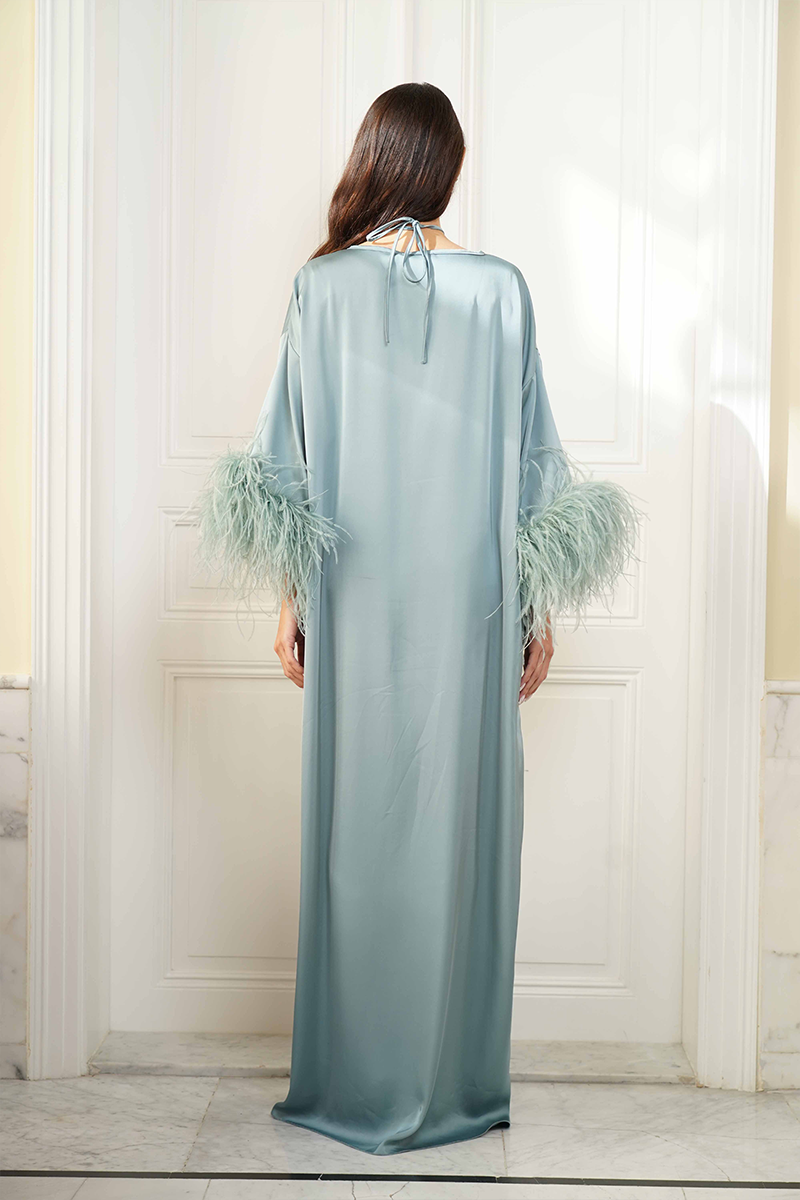 Joanna Andraos feather-sleeve silk gown with a tie-neck design, shown from the back in this elegant, flowing dress image.