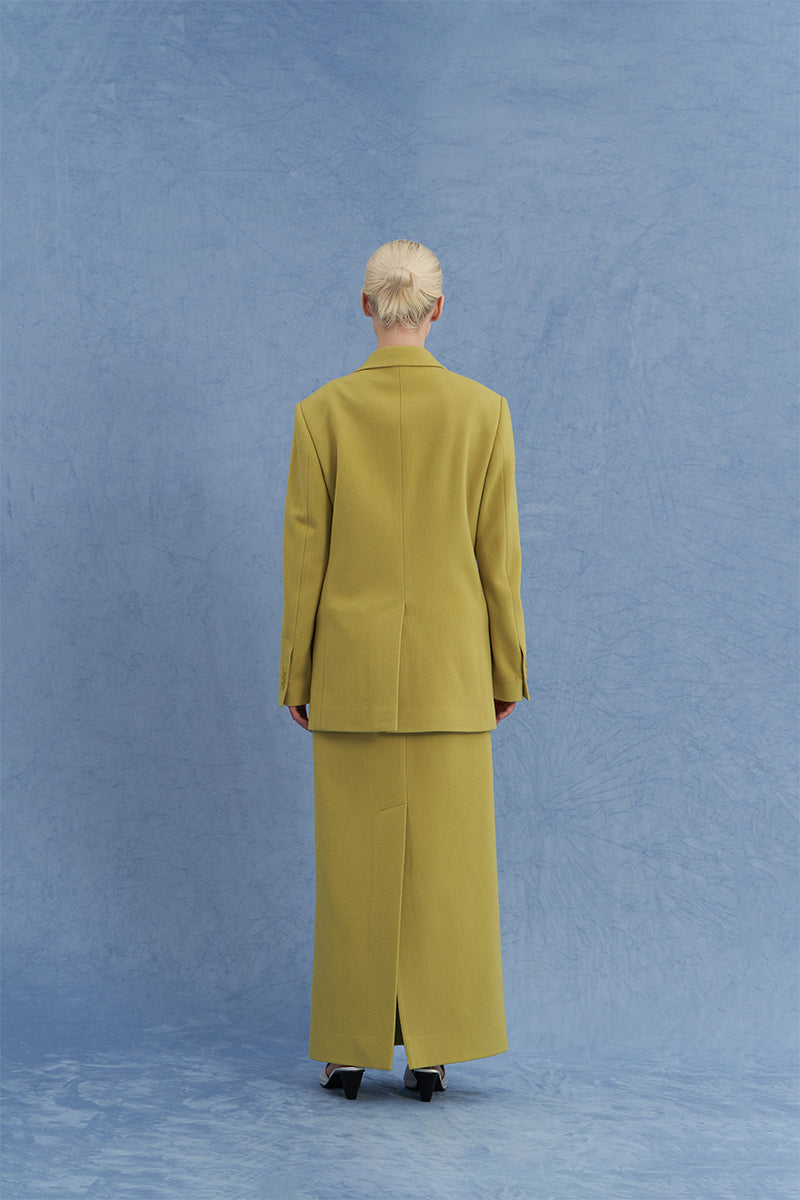 Back view of JINSUN double-breasted green wool jacket, showcasing classic collar, shoulder details, and tailored fit.