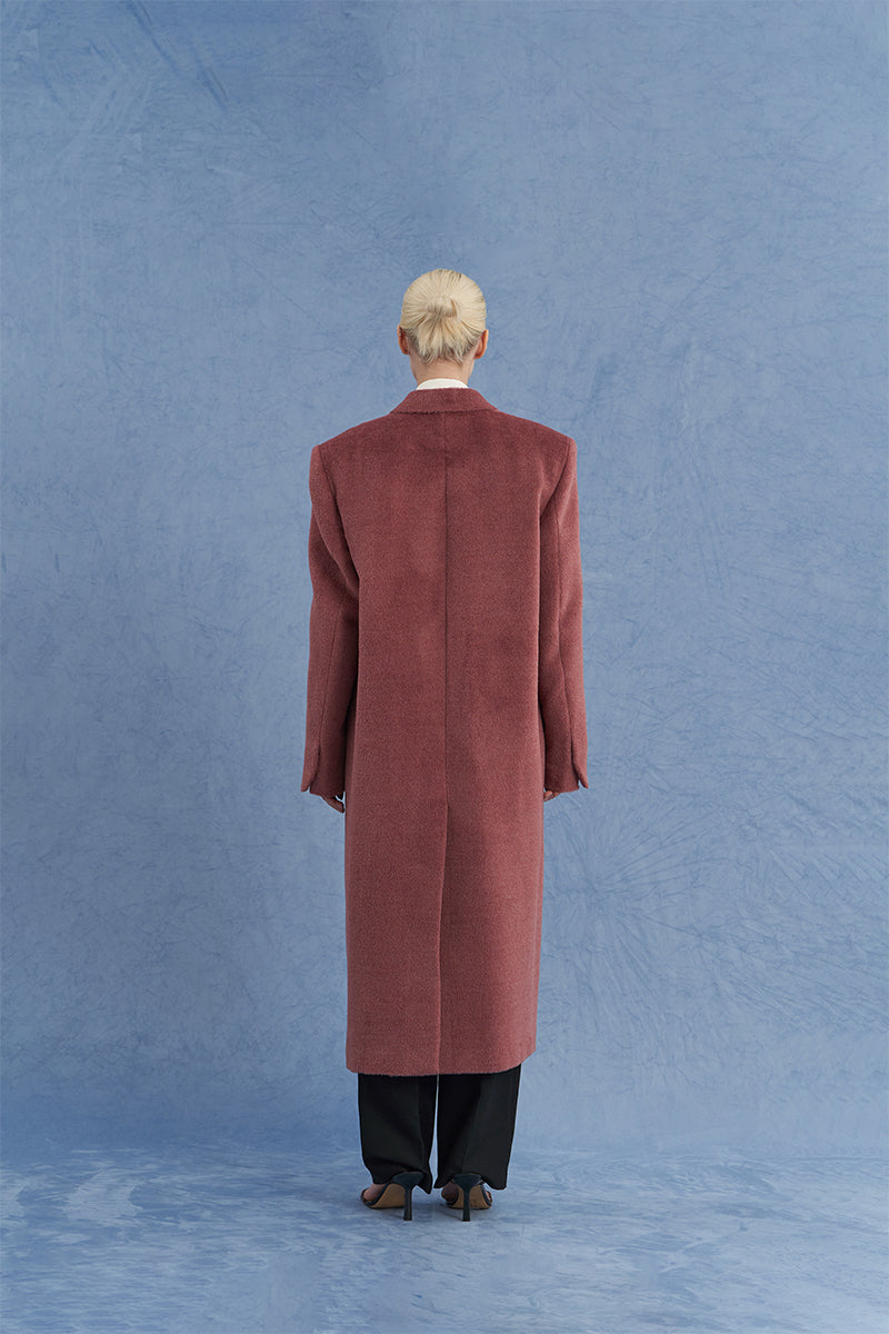 Pink oversized Suri alpaca coat by JINSUN shown from the back with plush, textured fabric and relaxed fit.