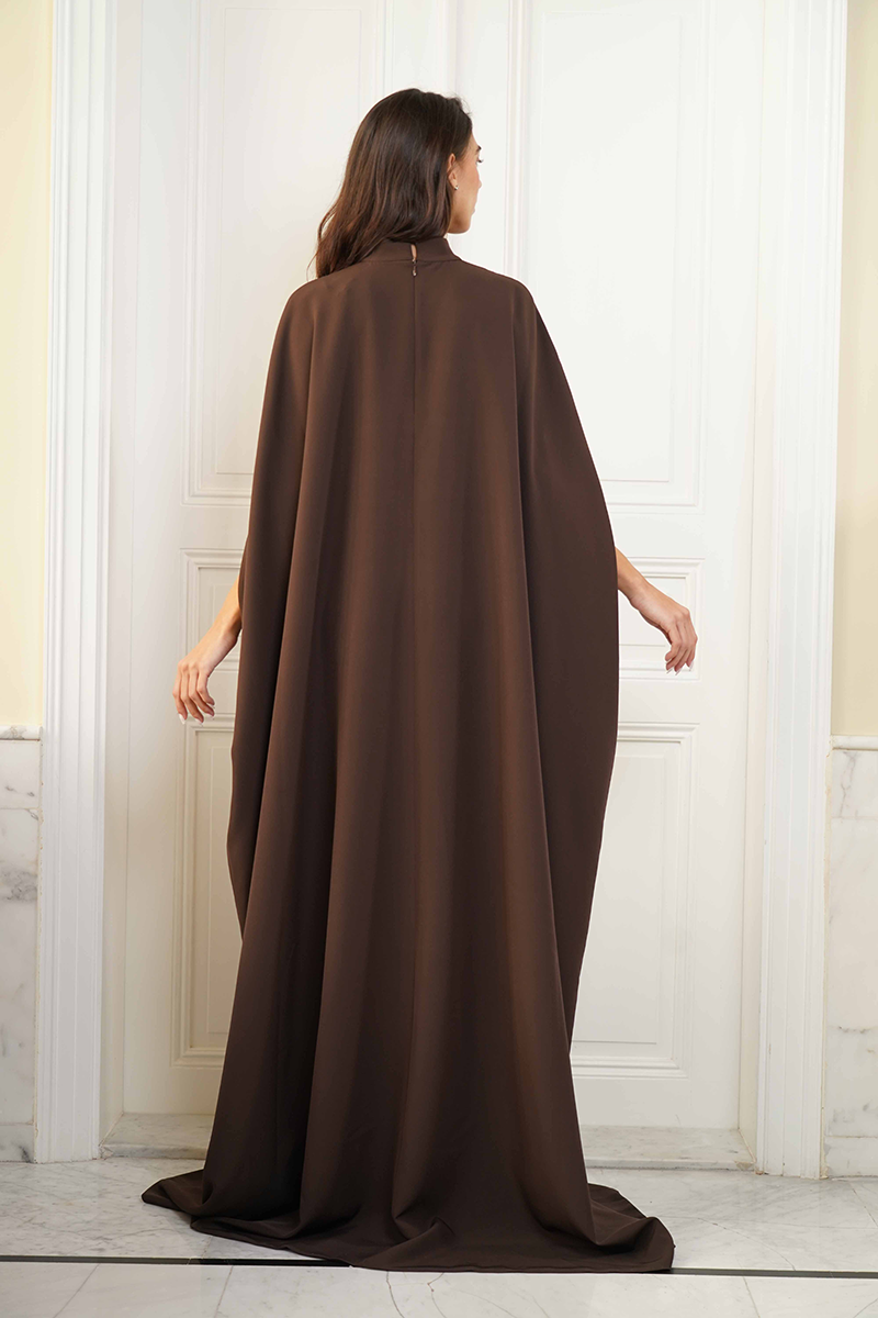 Joanna Andraos CULT MIA X Joanna Andraos gown featuring a fitted corset dress with a detachable cape, shown from the back.