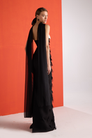 Black feather corset gown by Joanna Andraos, showing the back with intricate feather detailing and fitted design.