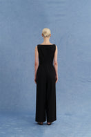 Black asymmetric-beck sleeveless jumpsuit by JINSUN, shown from the back with a stylish, modern design and fitted silhouette.