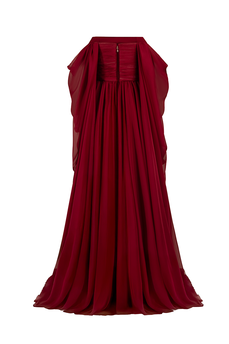 Red strapless gown by Joanna Andraos, shown from the back with a flowing, elegant design and fitted bodice.