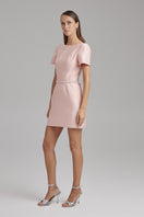 Pink LARA fondant mini dress by BAÉ with a diamond belt, featuring a fitted silhouette and stylish design for elegant occasions.