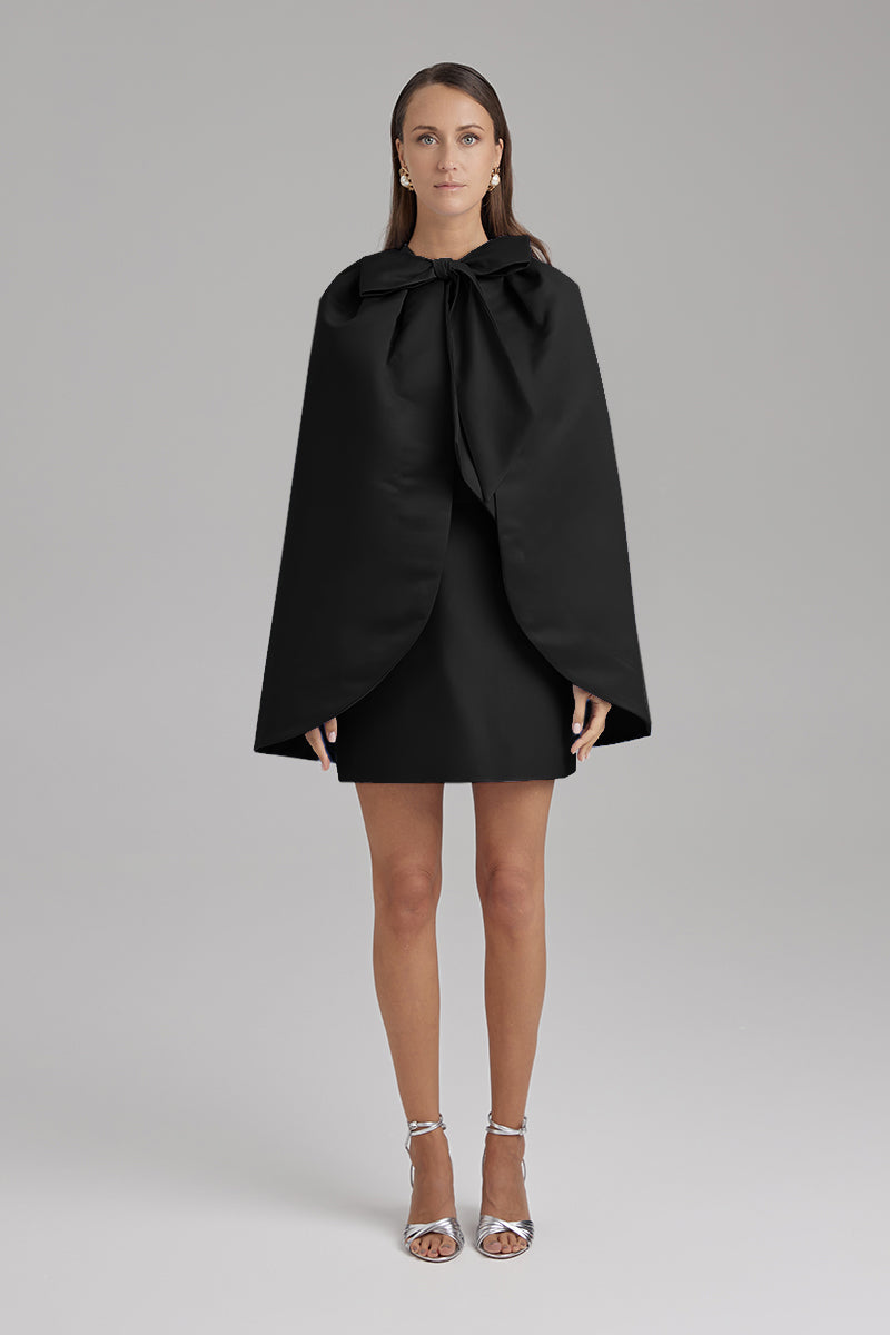 Black IRIS JET Cape jacket by BAÉ featuring a sleek, modern design and flowing fabric, styled for a fashionable look.
