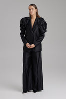Black BAÉ ONYX pants shown on a model, featuring a sleek fit and modern style, ideal for casual or stylish wear.