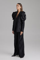 Black BAÉ ONYX Pants displayed on a model, showcasing a stylish, slim-fit design with a tailored waistband and sleek fabric.