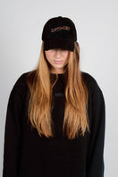 Black Bassigue Optimist embroidered cap with adjustable fit, featuring stylish embroidery on the front.
