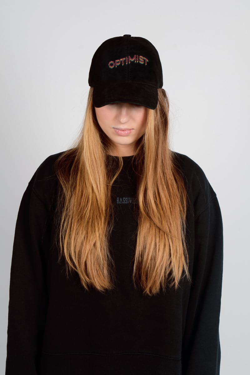 Black Bassigue Optimist embroidered cap with adjustable fit, featuring stylish embroidery on the front.